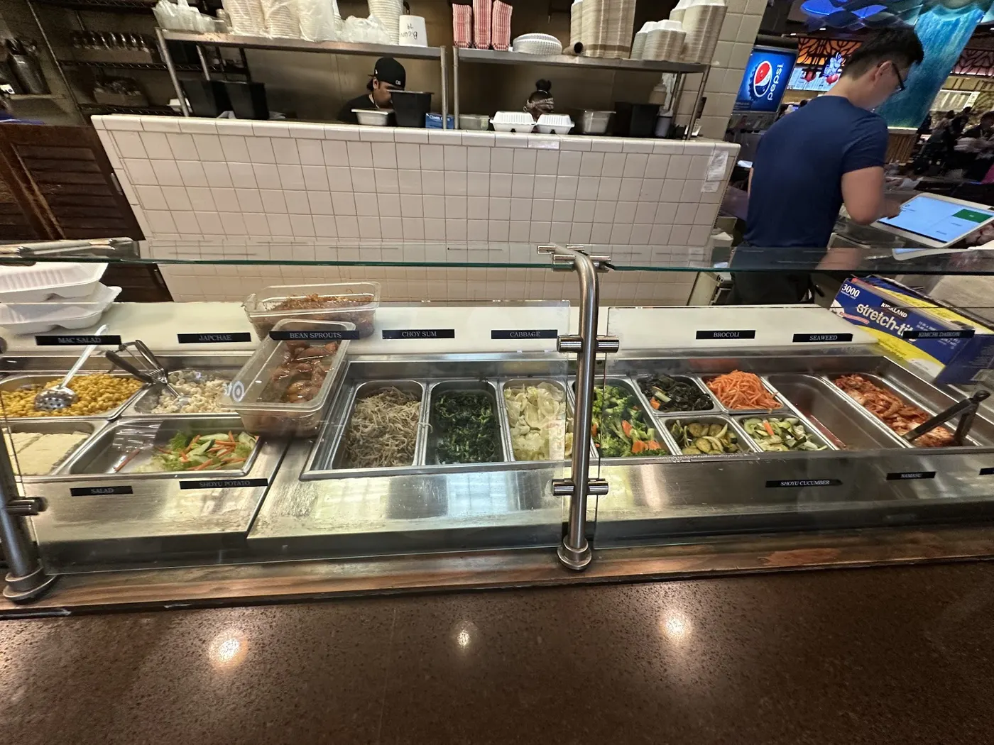 The Bull Kogi side-dish counter with kimchi and vegetables